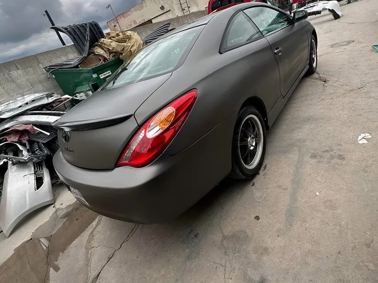 Toyota Solara coupe finished in matte gray paint in the shop yard